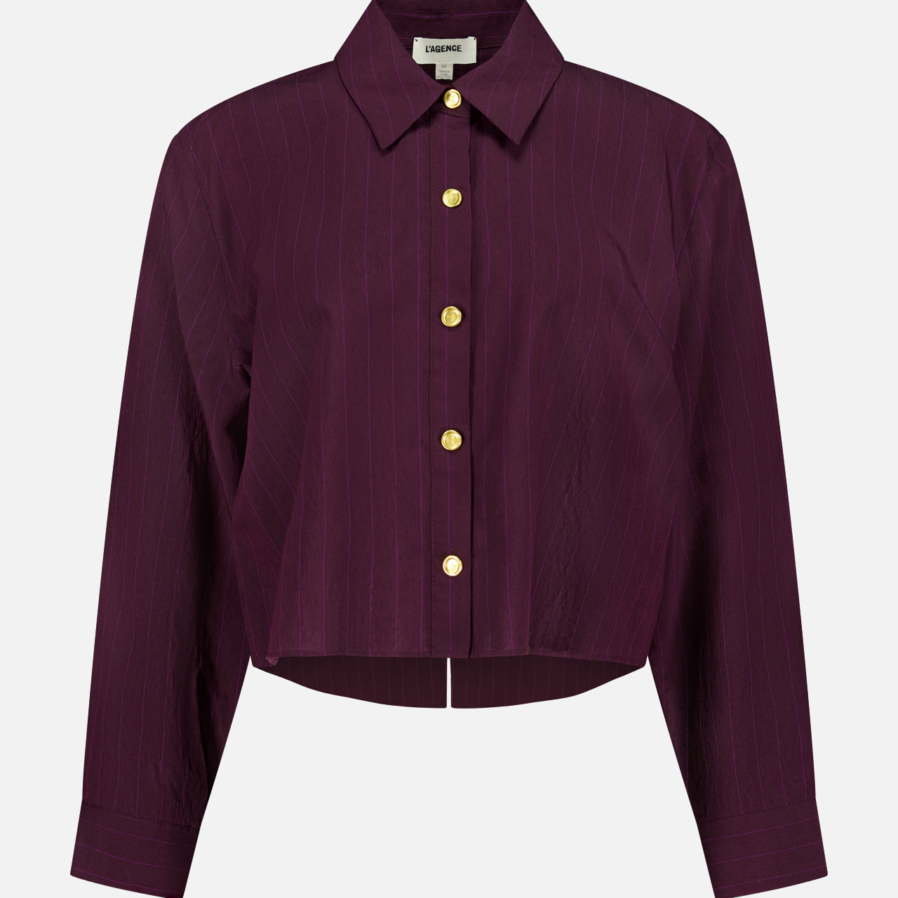 The Cosette Crop Hi Low Shirt by L'AGENCE is a long-sleeve burgundy pinstripe button-up with a pointed collar, gold-tone coin buttons, a slightly cropped high-low hem, and a boxy fit.