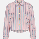The L'AGENCE Cosette Crop Hi Low Shirt is a pink, long-sleeve, collared top with blue and white vertical stripes, gold buttons, a cropped high-low hem, and is made from organic cotton. Displayed on a plain white background.