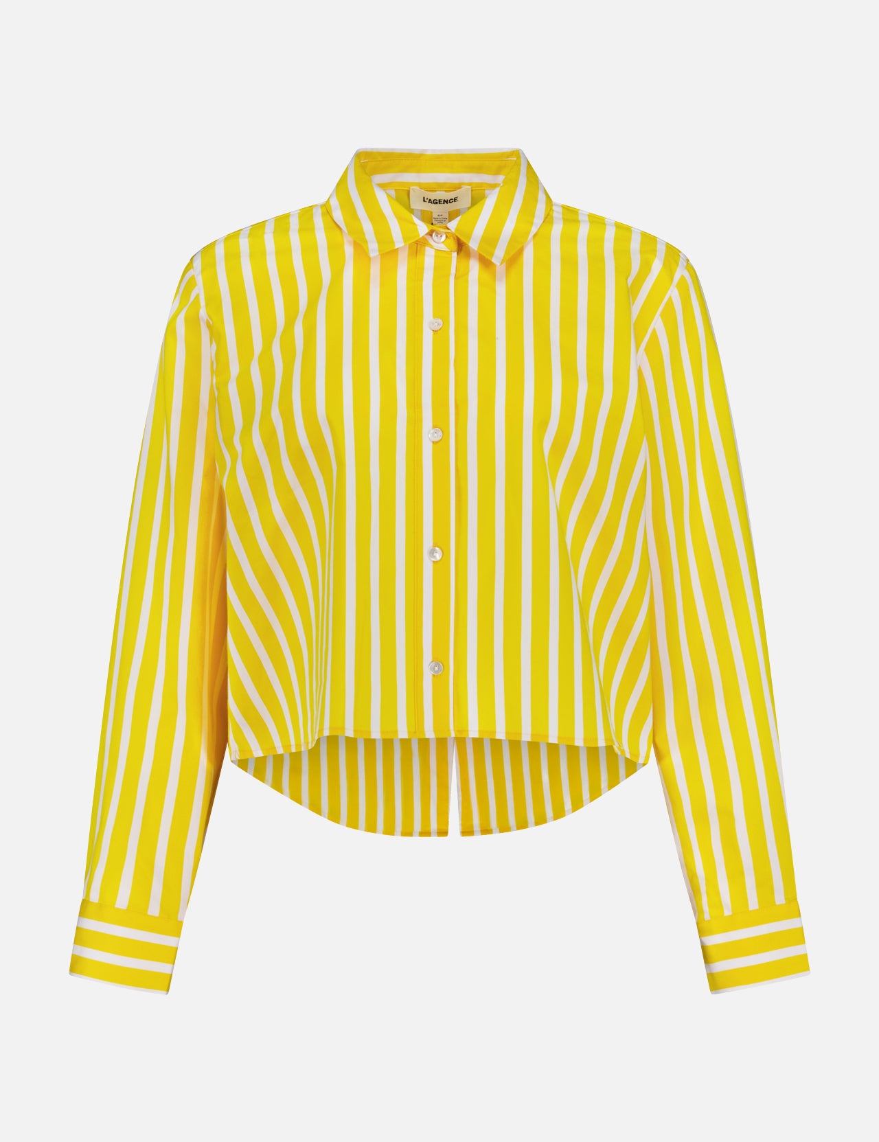 The Cosette Crop Hi Low Shirt by L'AGENCE is a collared, long-sleeve button-up with bold yellow and white vertical stripes and a gently curved hem.