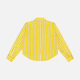 The Cosette Crop Hi Low Shirt by L'AGENCE is shown from the back, featuring vertical yellow and white stripes, buttoned cuffs, and a straight collar. Made from organic cotton, this cropped shirt stands out against a plain white background.