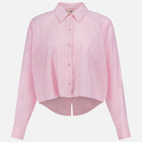 The Cosette Cropped Back Slit Shirt by L'AGENCE is a light pink cotton long-sleeve shirt with white vertical stripes, a pointed collar, and a cropped hem. Displayed on a plain white background.