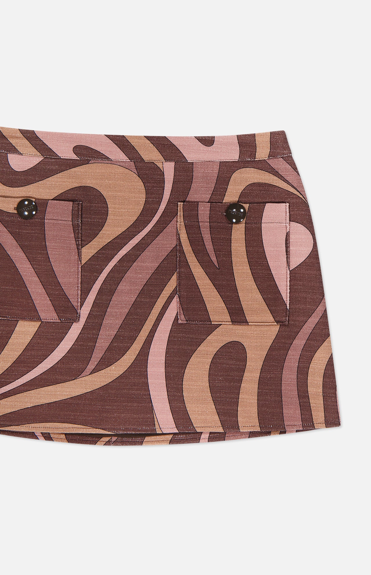 A close-up of the L'AGENCE Cyra Low Rise Mini Skirt showcases its brown and pink abstract swirl print, two front pockets each fastened with a black button, and an eye-catching low-rise silhouette.
