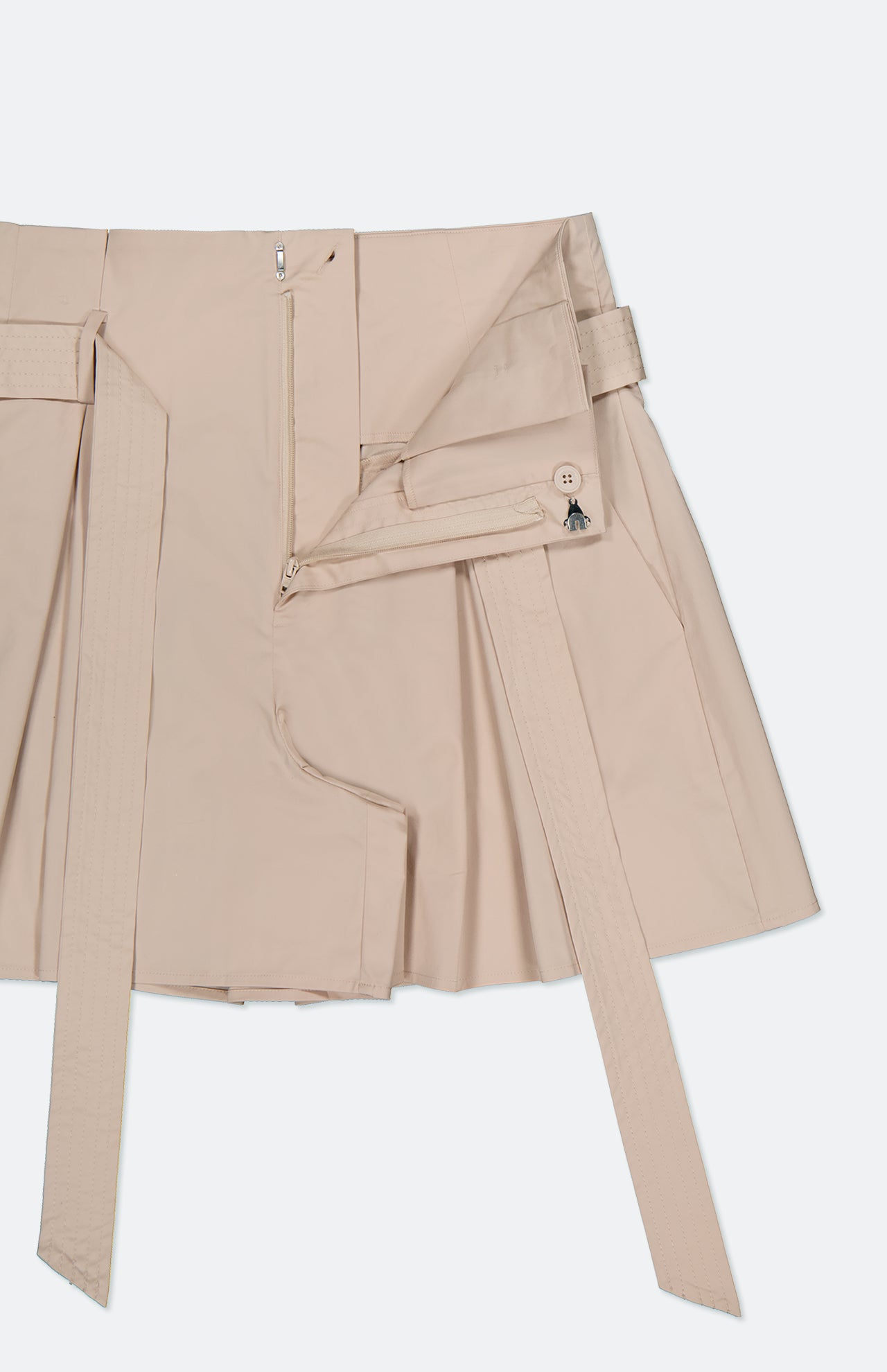 The Damira Paperbag Short by L'AGENCE features a beige pleated design with an open front zipper, visible button, two long self-tie belts, and a structured waistband, offering a tailored look inspired by high-rise shorts.