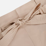 Close-up of the beige self-tie belt in a bow at the waist of L'AGENCE’s Damira Paperbag Short, showcasing the stitching and smooth material.
