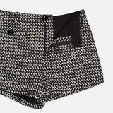 L’Agence Dionne Sparkling Tweed Short in high-rise black and white tweed featuring a button closure and a side zipper.