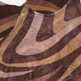 A close-up of the L'AGENCE Elowen Underwire Swirl Print Bodysuit showcases its sheer mesh fabric adorned with abstract, wavy patterns in brown, tan, and beige. The elegant swirl print and subtle sepia tones add depth and visual interest, making this a modern statement piece.