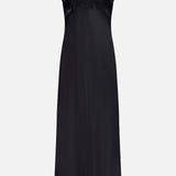 The Elsa Lingerie Maxi Dress by L'AGENCE is a black satin slip dress with thin straps, a deep V-neckline, and lace trim on the bust and straps. It offers a smooth, elegant finish and a timeless silhouette perfect for evening wear.