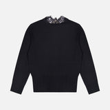 The Eluna Lace Detail Cardigan by L’AGENCE is shown from the back in black, featuring a delicate lace trim detail along the neckline. This long-sleeve v-neck cardigan has a lightweight, classic design with a straight hem and no visible fastenings.