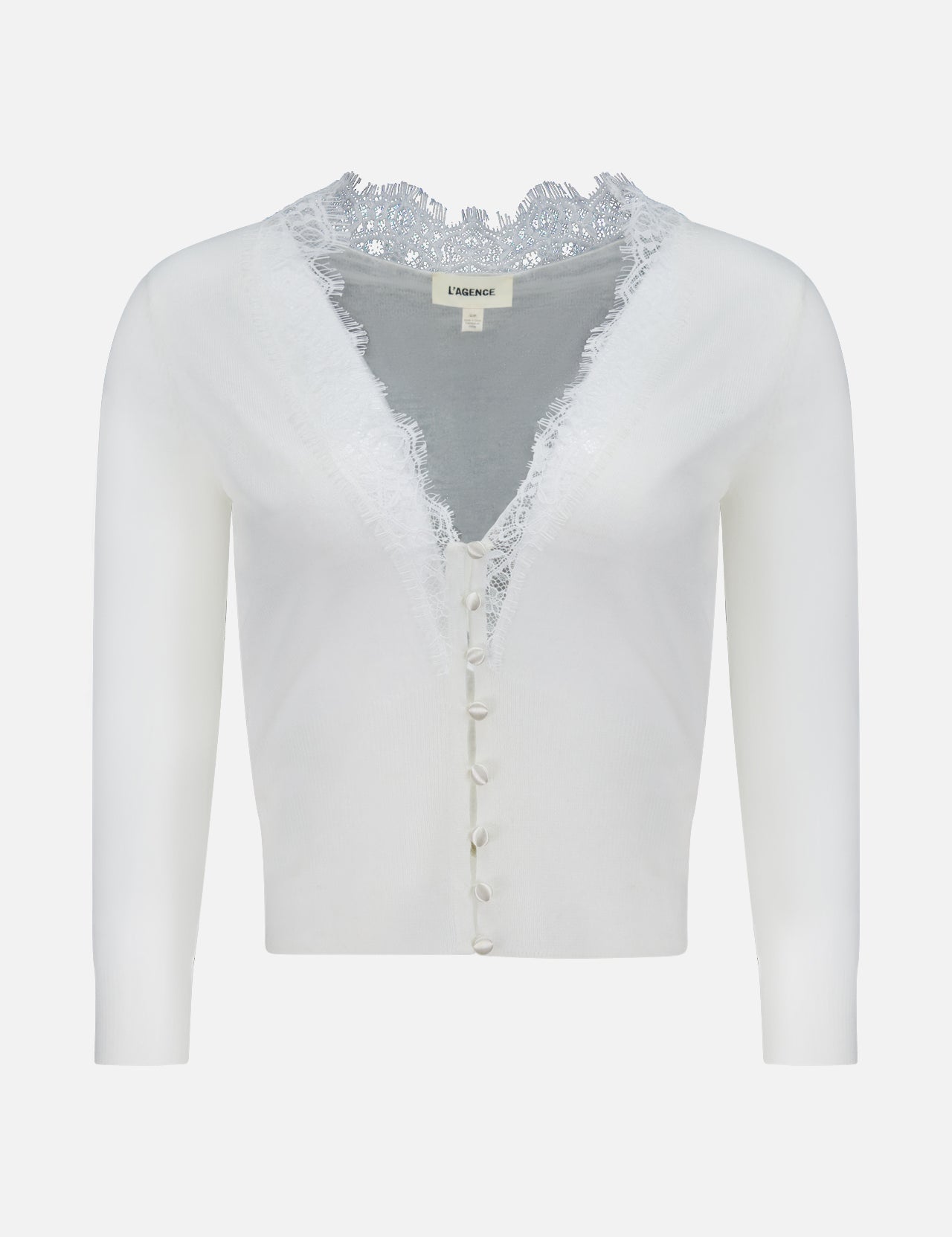 The Eluna Lace Detail Cardigan by L'AGENCE is an off-white, long-sleeve cardigan with a deep V-neckline, lace trim on the collar, and fabric-covered front buttons.