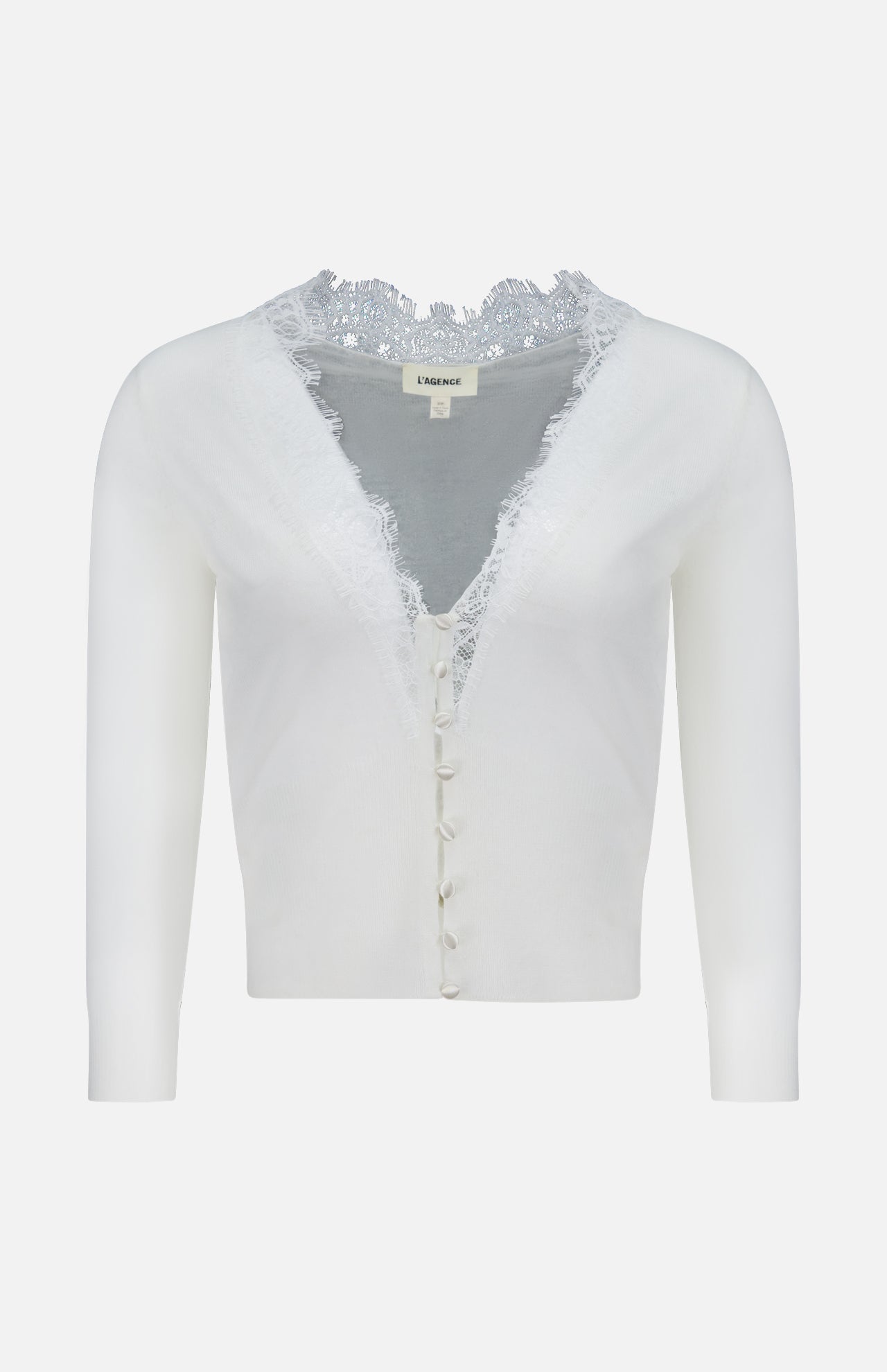 The Eluna Lace Detail Cardigan by L'AGENCE is an off-white, long-sleeve cardigan with a deep V-neckline, lace trim on the collar, and fabric-covered front buttons.