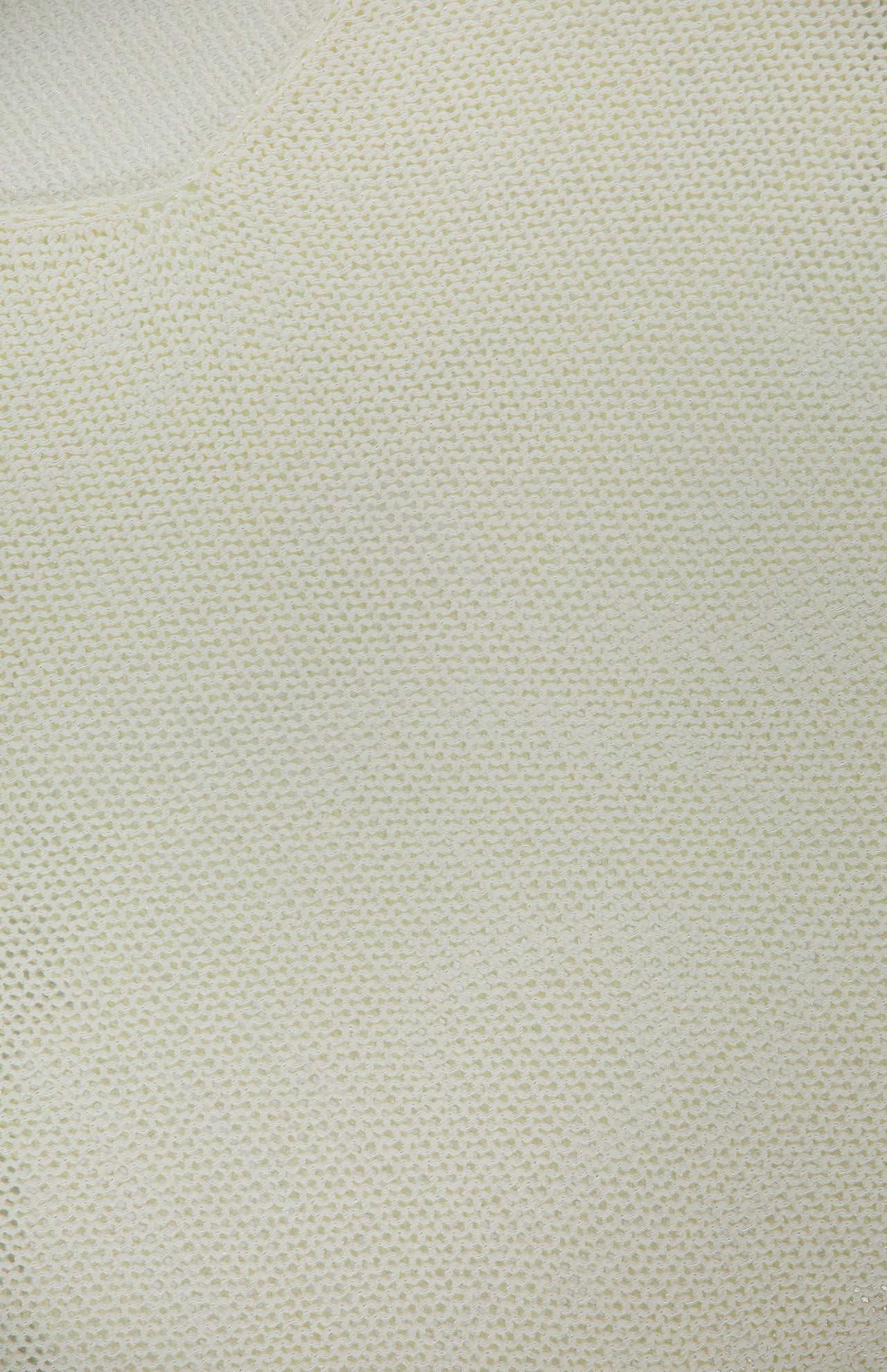 Close-up of the Ethan Knit Pullover Sweater by L'AGENCE, featuring soft, slightly stretchy off-white open-weave knit with a subtle textured pattern filling most of the frame.