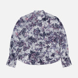 The Eunice Ruffle Sleeve Blouse by L'AGENCE is a sheer chiffon button-down with a high neck, purple and pink floral print, wide ruffled cuffs, and a loose fit, shown flat on a white background.