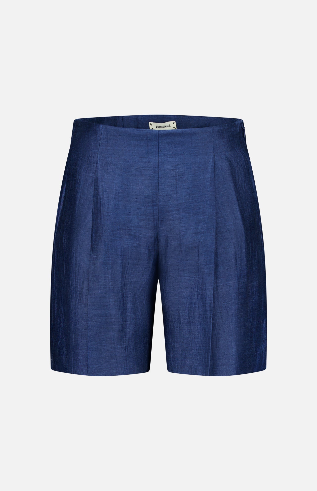 The Hadleigh Long Linen Short by L’AGENCE features a tailored high-rise fit in dark blue linen-blend with subtle pleats and a flat front, shown against a plain white background.