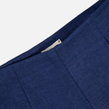 Close-up of the L'AGENCE Hadleigh Long Linen Short in dark blue, showcasing a concealed side zipper against a plain light background.