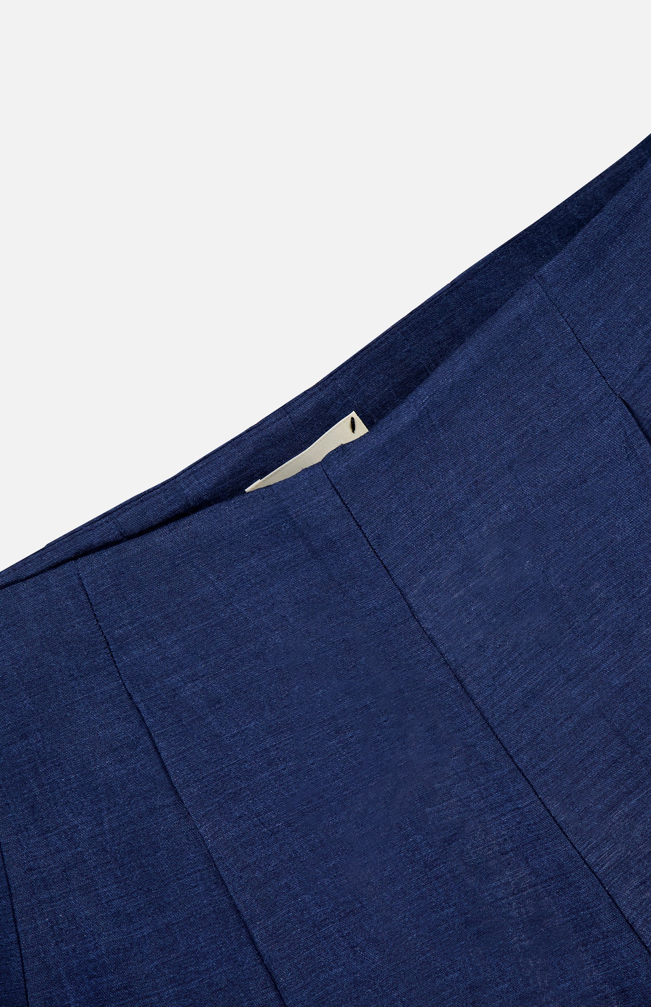 Close-up of the L'AGENCE Hadleigh Long Linen Short in dark blue, showcasing a concealed side zipper against a plain light background.