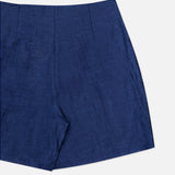 A close-up of the Hadleigh Long Linen Short by L'AGENCE—high rise blue linen dress shorts with a smooth texture and flat front, photographed against a white background.