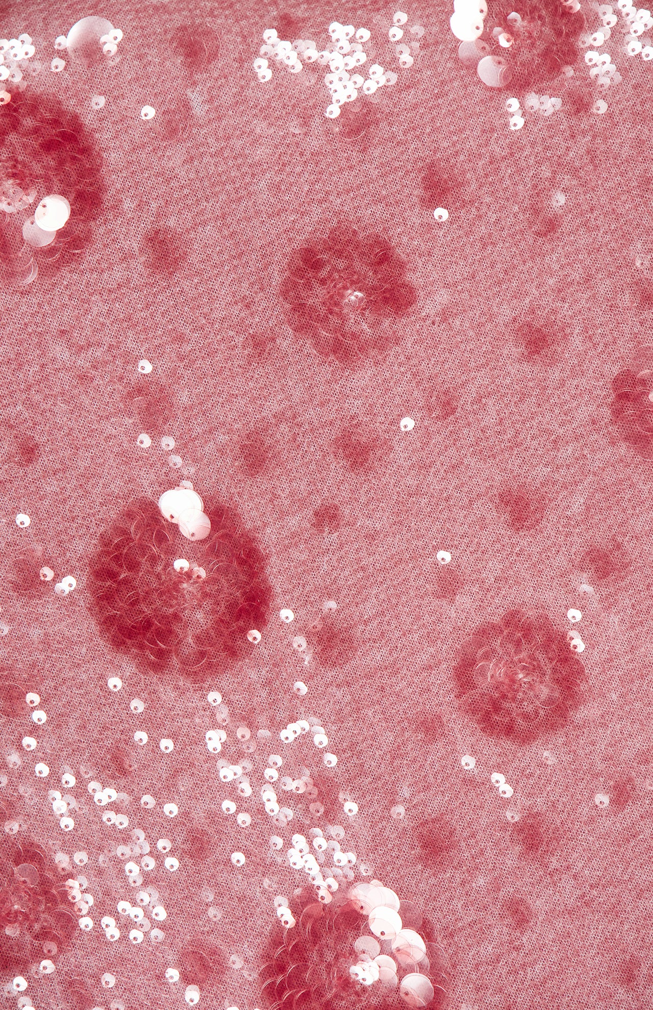 Close-up of the Karma Sequin Maxi Dress by L'AGENCE, featuring pink fabric embellished with circular rose-pattern sequins and embroidery for a textured, sparkling effect—perfect as a party dress.