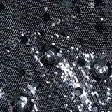 The L’Agence Karma Sequin Maxi Dress features black fabric covered in rows of tiny silver sequins and rose-pattern sequin clusters.
