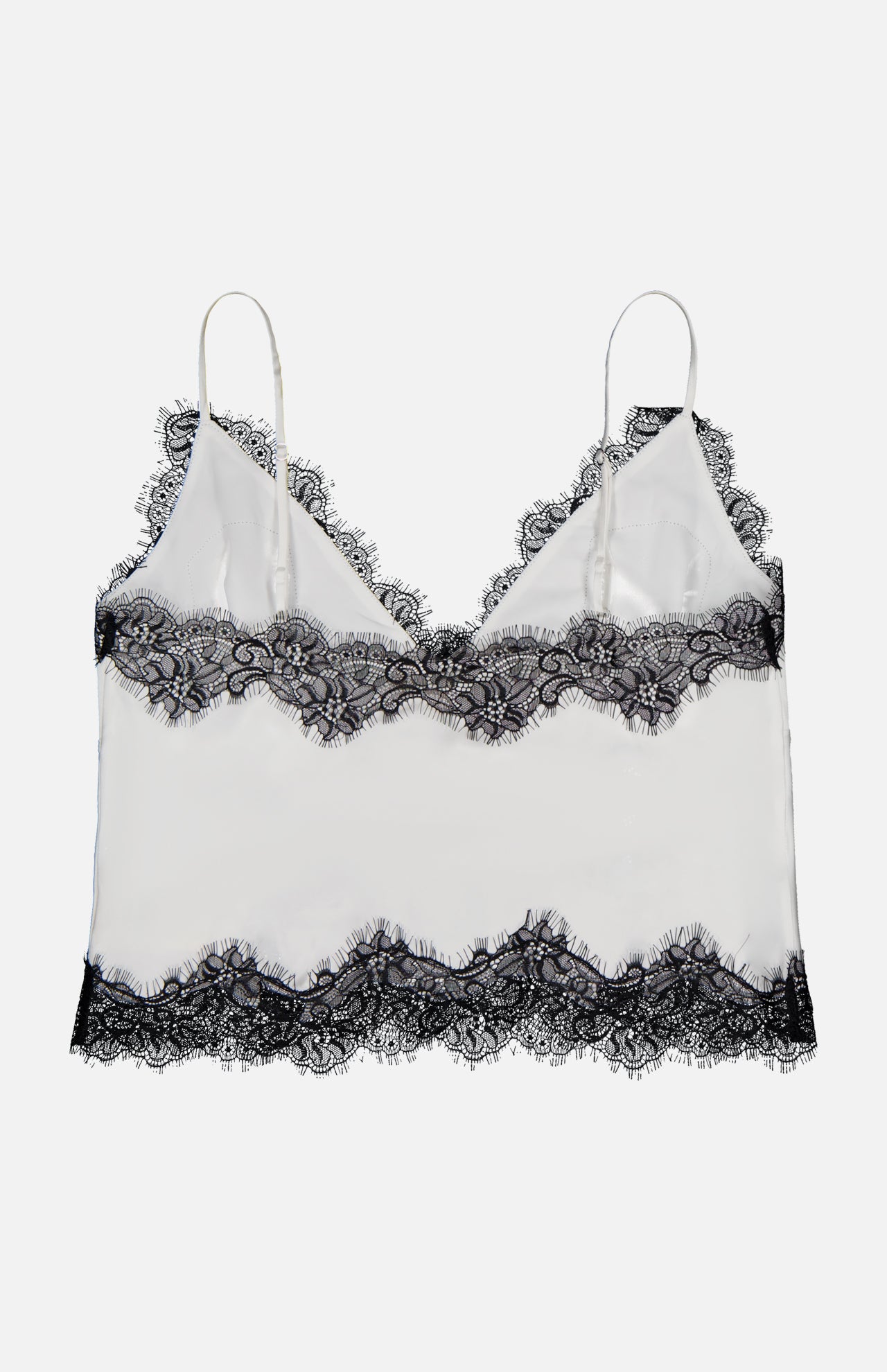 The Kimber Lace Insert Cami by L’AGENCE is a white satin camisole with adjustable spaghetti straps and black lace trim at the neckline, hem, and bust. Photographed on a plain white background.
