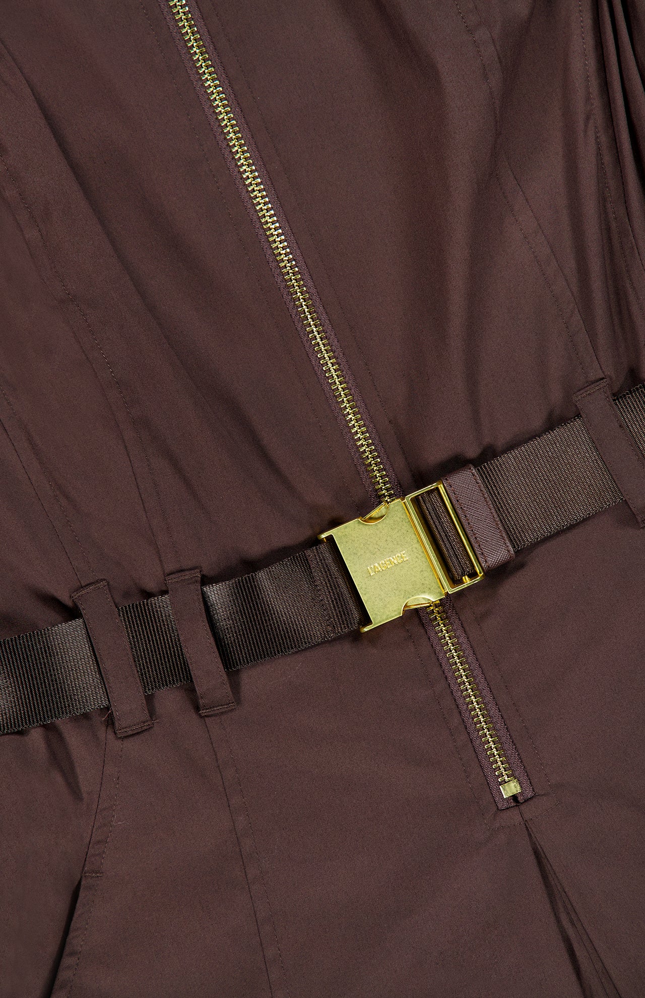 Close-up of the Kolton Midi Dress by L’AGENCE in dark brown, featuring a visible gold zipper and a matching brown belt with a rectangular gold buckle engraved with “Vince.”.