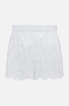 The L'AGENCE Laina Pull On Eyelet Short features a floral eyelet design, elastic waistband, scalloped hem, and cotton lining with a semi-sheer overlay for a delicate look.