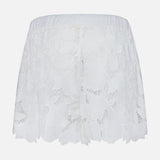 The Laina Pull On Eyelet Short by L'AGENCE features a floral eyelet design, elastic waistband, and scalloped edges, shown on a simple light background.