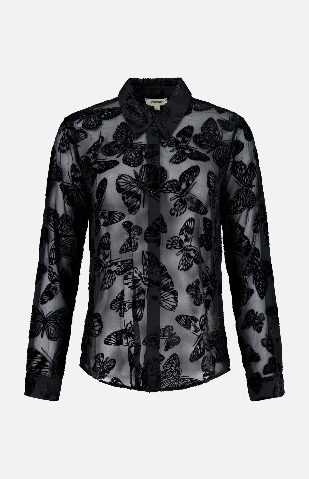 The Laurent Button Up Butterfly Blouse by L’AGENCE is a sheer black statement top with long sleeves, showcasing an all-over butterfly pattern in a striking burnout velvet design and finished with a classic collar, displayed on a plain white background.