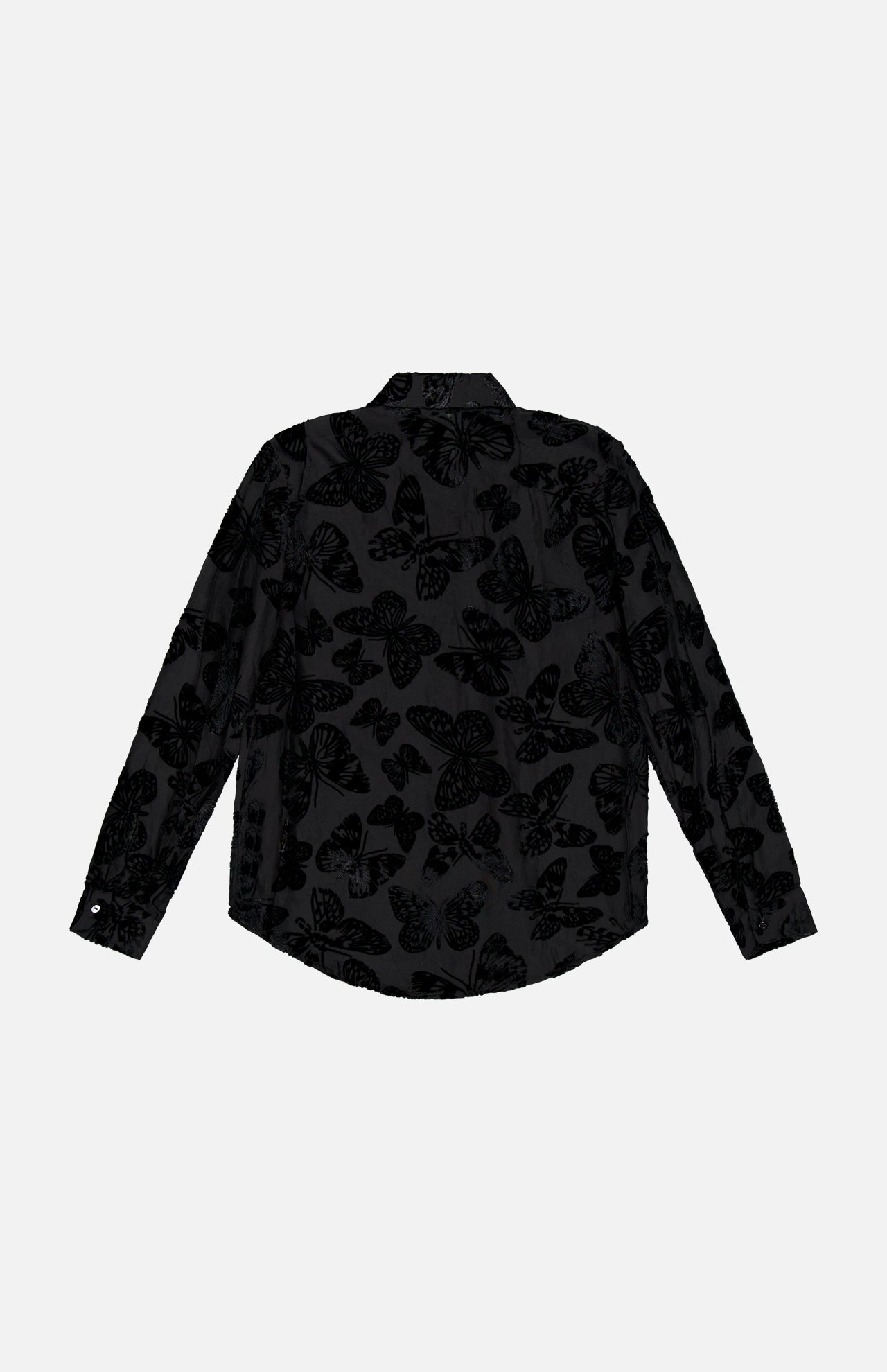 The Laurent Button Up Butterfly Blouse by L’AGENCE is a long-sleeve, black statement top featuring a subtle, semi-transparent butterfly pattern throughout. It is shown from the back against a plain white background.