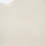 Close-up of the Lexi Silk Camisole by L'AGENCE in light beige pearl, highlighting its silky texture, subtle sheen, curved edge, and smooth finish that embody the elegance of this delicate camisole.