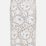 The Makena Sequin Pencil Skirt by L'AGENCE is a knee-length, white pencil skirt with a delicate lace floral design and nude underlayer, ideal for bridal parties, shown against a plain white background.