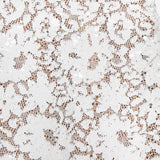 Close-up of the Makena Sequin Pencil Skirt by L'AGENCE, featuring intricate white lace with a floral pattern. The sheer design stands out against a neutral background, highlighting its delicate texture and exquisite details.