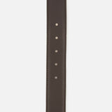 Chocolate brown L’Agence Marcaeu Baroque Belt featuring a gold-tone statement buckle, pointed tip, and four visible adjustment holes.