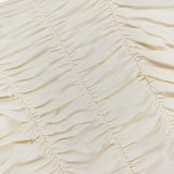 The Mixie Ruched Bodysuit by L'AGENCE features cream-colored stretch mesh with vertical gathered seams for a textured, slightly wrinkled look.