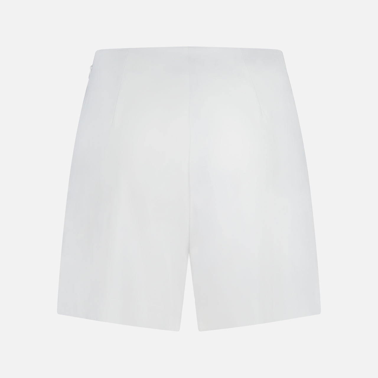 Back view of the L'AGENCE Naamah Pleated Stretch Short in white, shown against a white background. These wrinkle-resistant shorts feature a smooth texture, minimal design, and no visible pockets—ideal for resort wear.