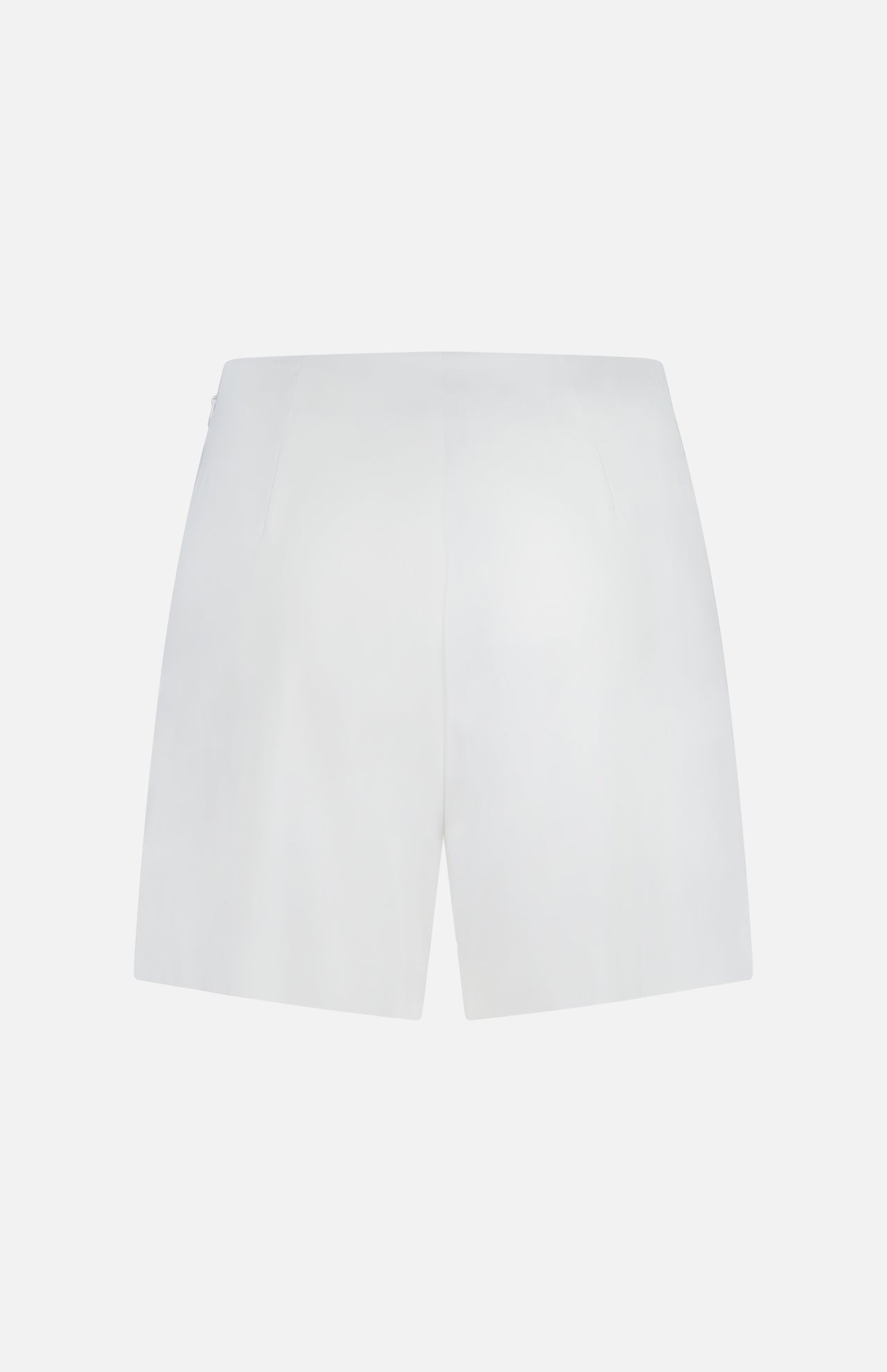 Back view of the L'AGENCE Naamah Pleated Stretch Short in white, shown against a white background. These wrinkle-resistant shorts feature a smooth texture, minimal design, and no visible pockets—ideal for resort wear.