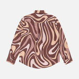 The Nina Long Sleeve Swirl Print Blouse by L'AGENCE features a bold, abstract swirl design in shades of brown, beige, and cream, shown laid flat with the back facing up.