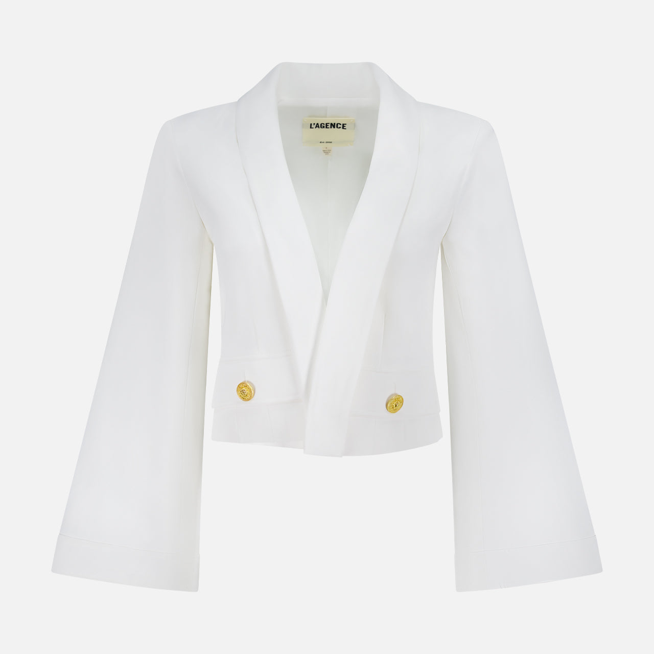 The L'AGENCE Nixie Wide Sleeve Cardigan Jacket in ivory features a cropped silhouette, wide flared sleeves, wide lapels, and two gold buttons on the front, shown against a plain white background.