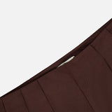 Close-up of the pleated waistband of dark chocolate brown, wide-leg L’Agence Nova Pleated Trouser Pant.