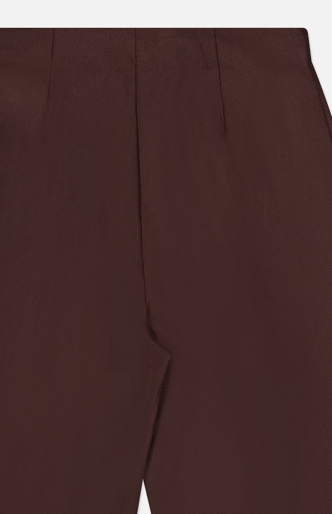 Close-up of the waist and front pleat detail of the L’Agence Nova Pleated Trouser Pant in dark chocolate brown.