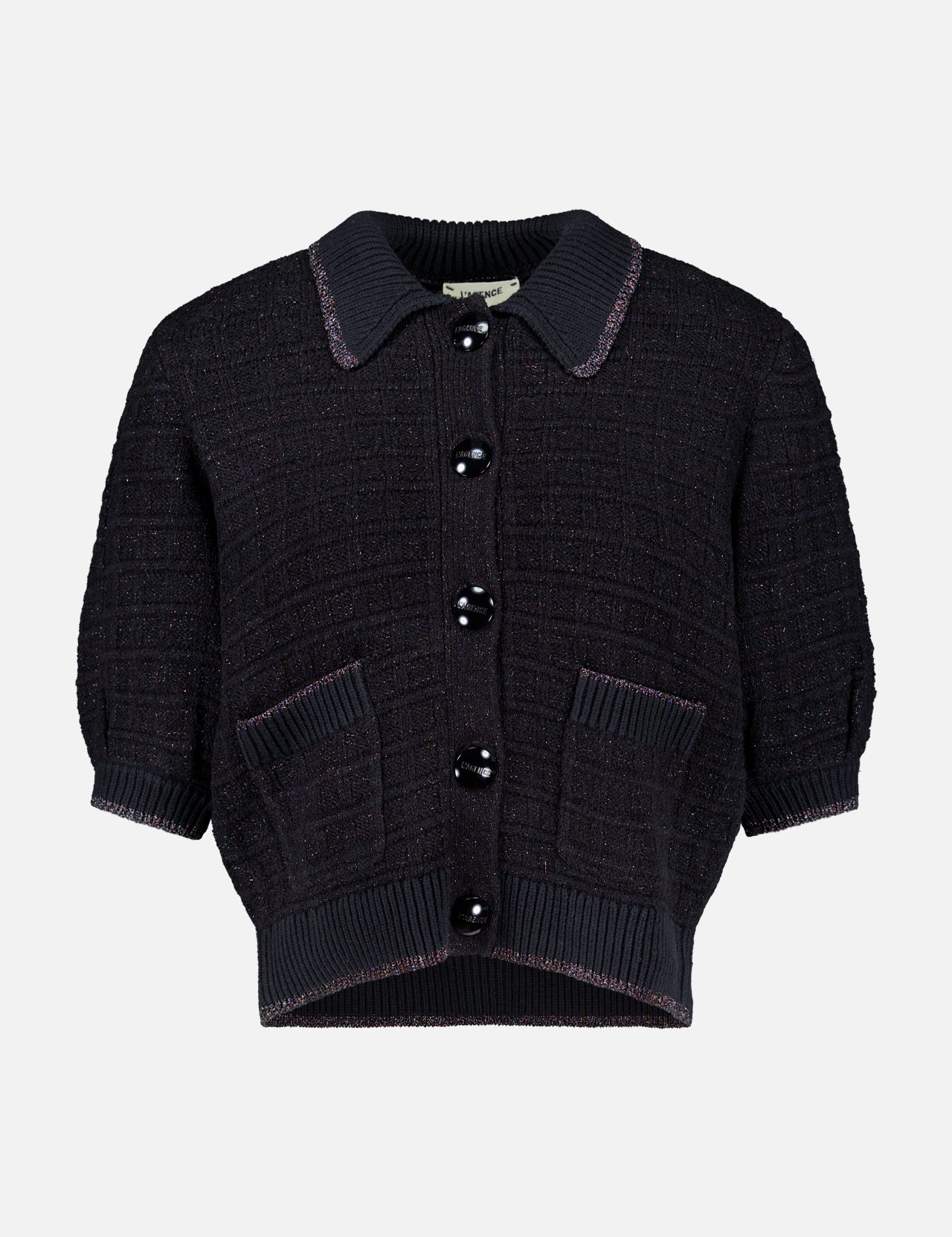 The Novalie Waffle Stitch Short Sleeve Cardigan by L’AGENCE features a short-sleeved, black textured knit design with a collar, large black buttons down the front, and two front pockets—offering effortless feminine style to any outfit.