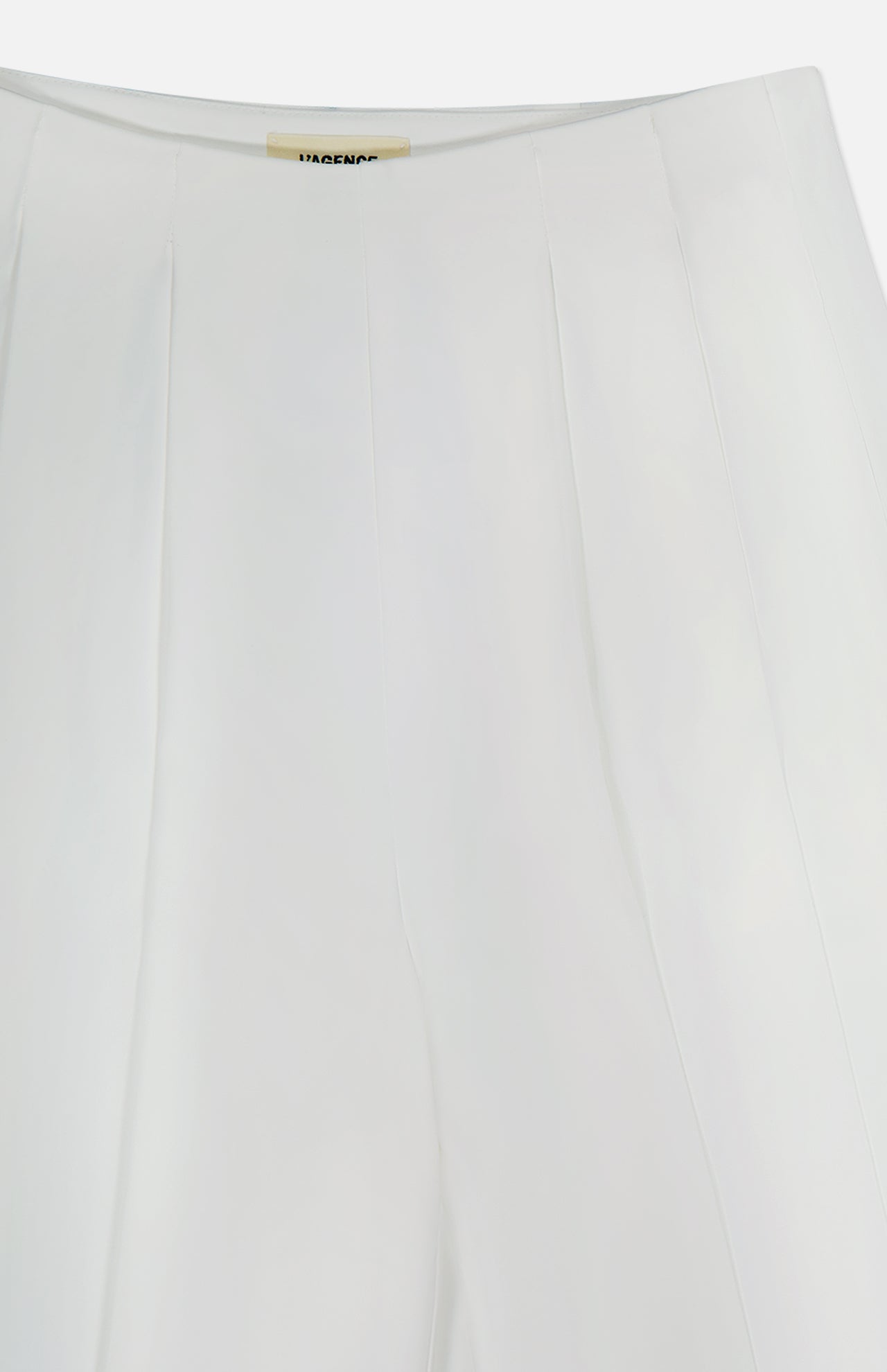 Close-up of the Novalynn Cropped Pleated Pant by L'AGENCE, featuring a white high-rise design with subtle vertical seams, showcasing the waistband and upper section of its wide-leg silhouette.