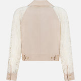 The Novelle Lace Sleeve Trench Coat by L'AGENCE features a solid beige back, long floral lace sleeves, buttoned beige cuffs, and a straight hem with button details. This lightweight coat is shown on a plain white background.