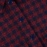 Close-up of the L’Agence NYX Cropped Tweed Jacket in a cotton-blend, burgundy and navy houndstooth pattern with dark blue buttons.