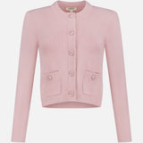 The Patsy Crop Crewneck Cardigan by L'AGENCE is a blush pointelle knit with long sleeves, a round neckline, front buttons, and two small front pockets, shown on a plain white background.