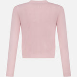 The Patsy Crop Crewneck Cardigan by L'AGENCE is a light pink, long-sleeve cardigan shown from the back, featuring a simple blush tone and plain design without visible patterns or embellishments.
