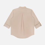The L'AGENCE Pearson Military Pocket Blouse in beige poplin is shown flat with the back facing up, featuring a center pleat and partially rolled sleeves.