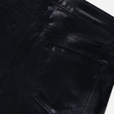 Close-up of the back pocket and waistband of the L’AGENCE Petite Kendra High Rise Crop Flare in Noir, highlighting stitching details, belt loops, and the slightly shiny black coated denim texture.