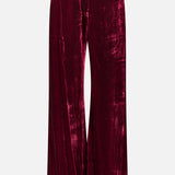 Deep red Pilar Wide Leg Velvet Trousers with a high-rise, wide-leg silhouette and belt loops.