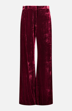 Deep red Pilar Wide Leg Velvet Trousers with a high-rise, wide-leg silhouette and belt loops.