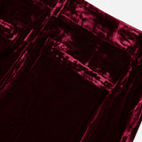 Close-up of the high-rise waistband and back pockets of the deep red L’Agence Pilar Wide Leg Velvet Trouser.